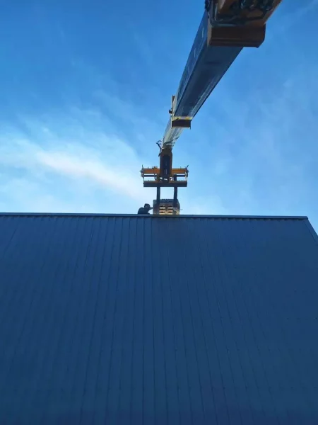 Technicien photovoltaique qui réceptionne une palette de panneaux photovoltaïques sur un toit
