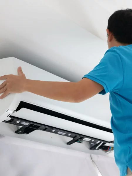 Un homme installe une climatisation unité intérieure