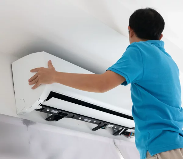 Un homme installe une climatisation unité intérieure